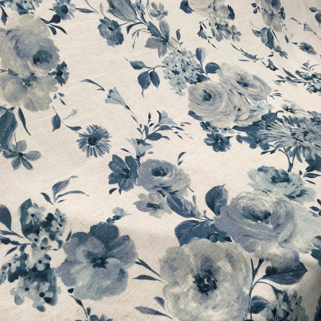 floral curtain fabric with grey/blue flowers on a pale background