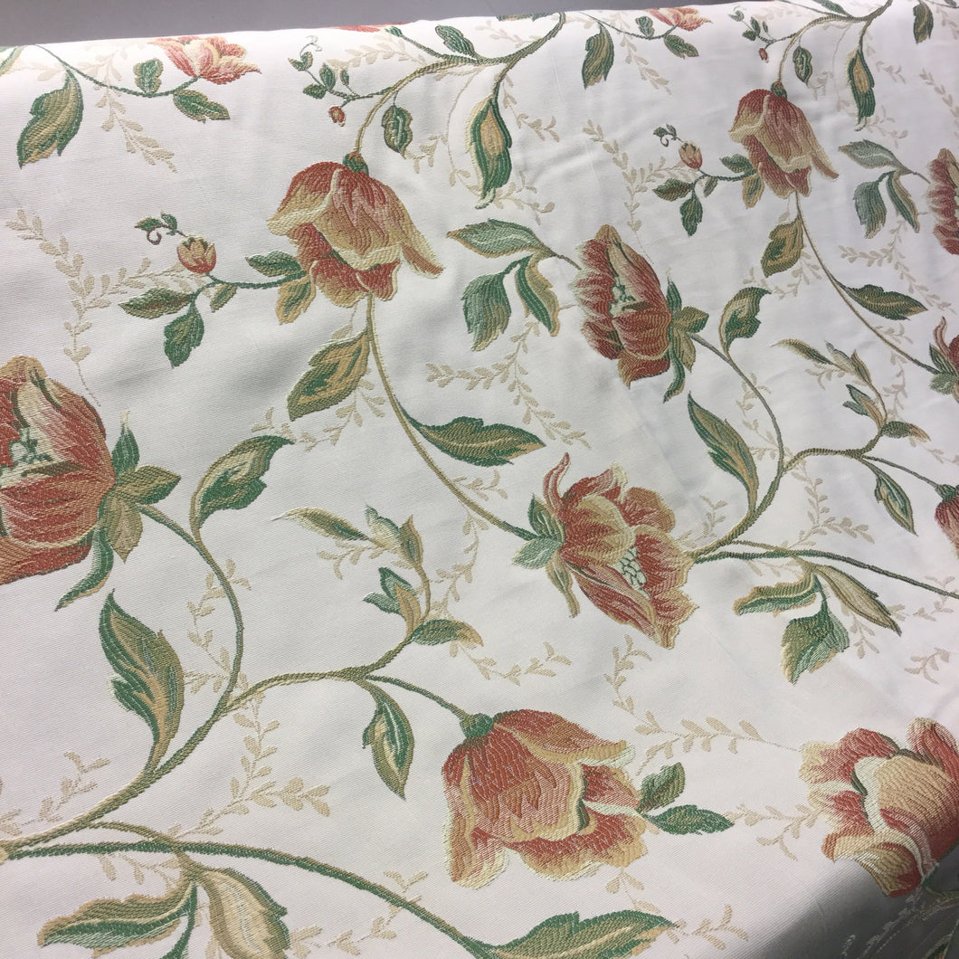 red floral embroidered fabric with a pale background