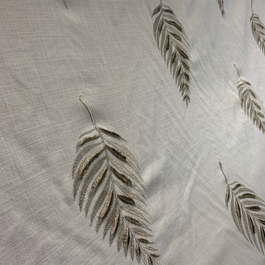 embroidered leaf fabric on a beige background