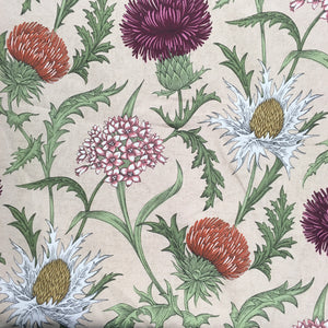 purple floral curtain and upholstery fabric with flowers and thistles on a neutral background